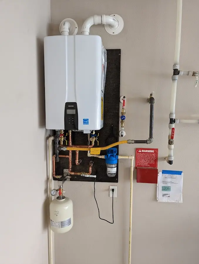 Professional plumber installing copper piping in a Chattahoochee Hills home